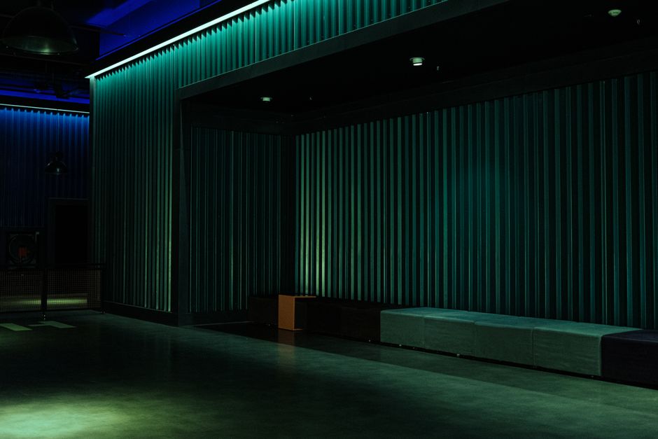 Empty theater space with industrial design and dramatic lighting, ideal for performances.