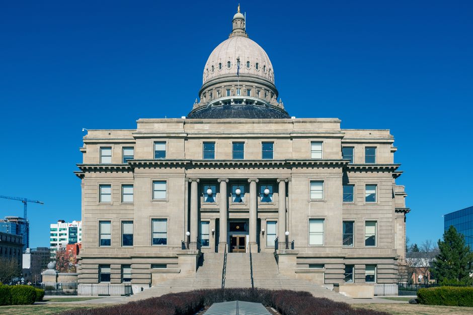 Front view of the historic Idaho State Capitol Building under blue skies in Boise.