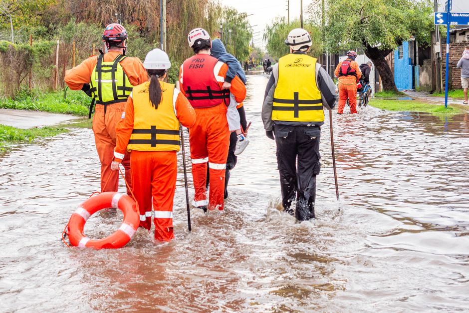 Rescue team evacuates flood victims in Buenos Aires. Humanitarian aid at work.