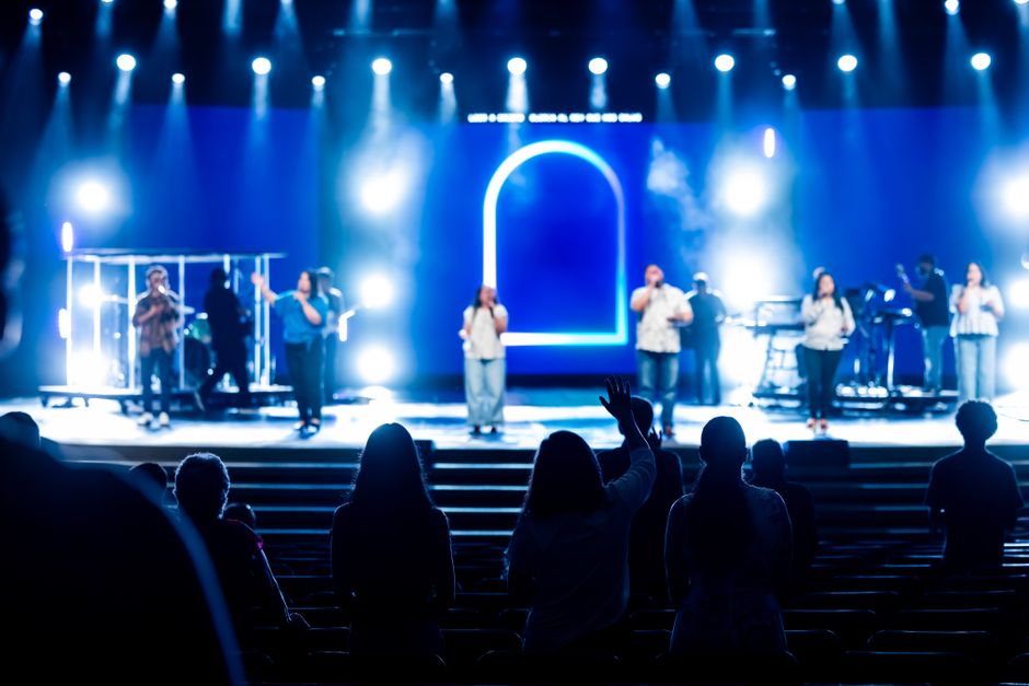 A vibrant live music concert with performers on stage and an engaged audience enjoying the event.