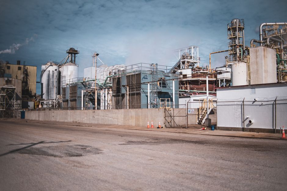 A detailed view of an industrial plant with steel structures under a cloudy sky, showcasing modern industrial architecture.