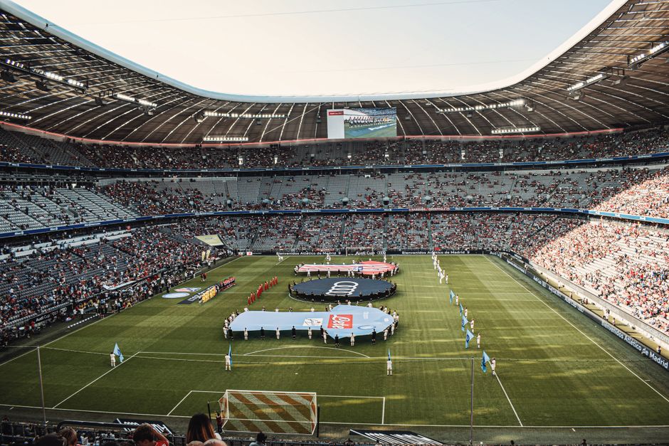 Captivating view of a soccer match at Munich's iconic Allianz Arena, filled with excited fans.
