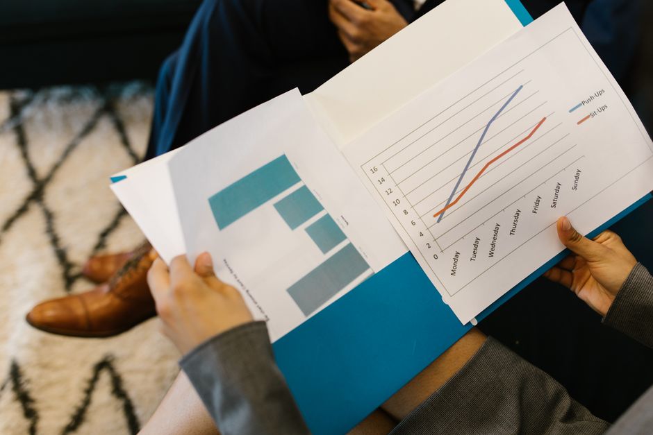 Detailed view of business reports with graphs during a corporate meeting.